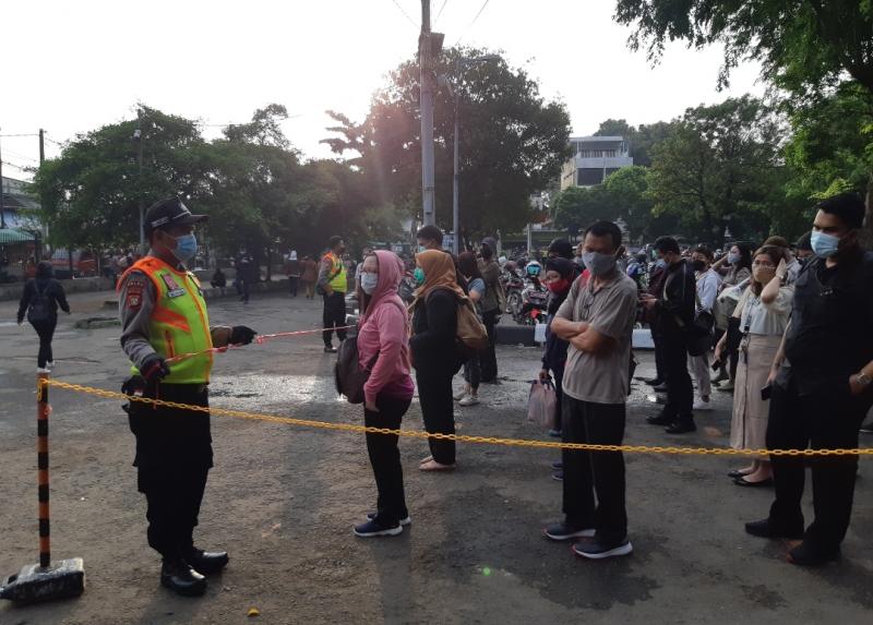 Satpam berjaga dan melakukan penyekatan terhadap pengguna KRL di Stasiun Bakasi, Senin (29/3/2021).