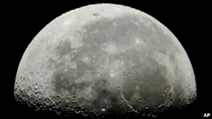 Stasiun Luar Angkasa Internasional, tengah, melintas di depan Bulan di orbit Bumi, Hongaria, 5 Juli 2018. Pada 4 April 2021, perusahaan eksplorasi Bulan, iSpace, mengatakan akan menerbangkan wahana penjelajah milik UEA ke Bulan pada 2022. (Foto: Peter Komka/MTI via AP)