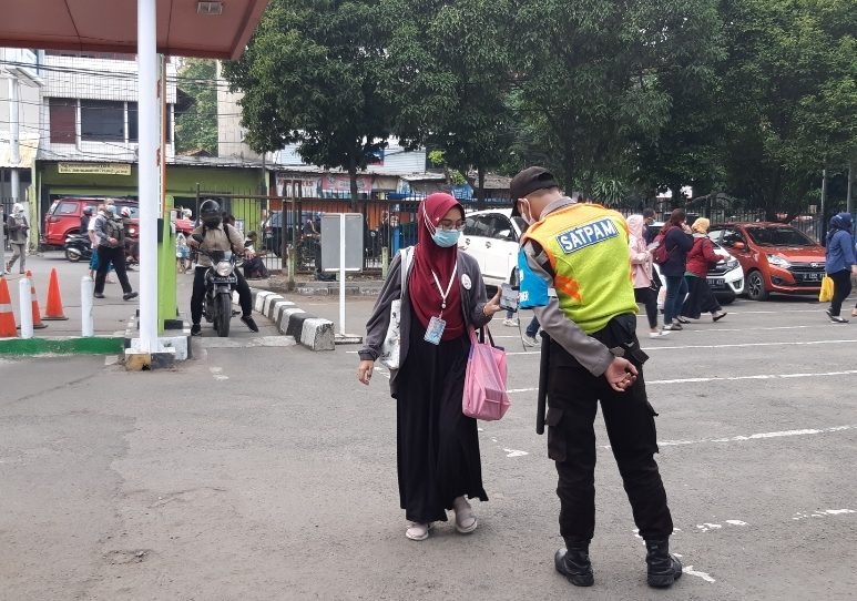 Penumpang KRL dengan pin Ibu Hamil menunjukan bukti vaksin kepada petugas di jalur prioritas untuk masuk menggunakan KRL tanpa antre di Stasiun Bekasi, Senin (4/10/2021) pagi.