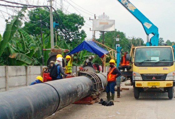 Pekerja sedang memasang pipa pada proyek pembangunan SPAM Bandarlampung. (Ist.)