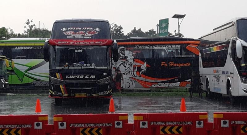 Bus parkir terkana hujan di area Terminal Pulo Gebang, Jakarta, Jumat (24/12/2021).