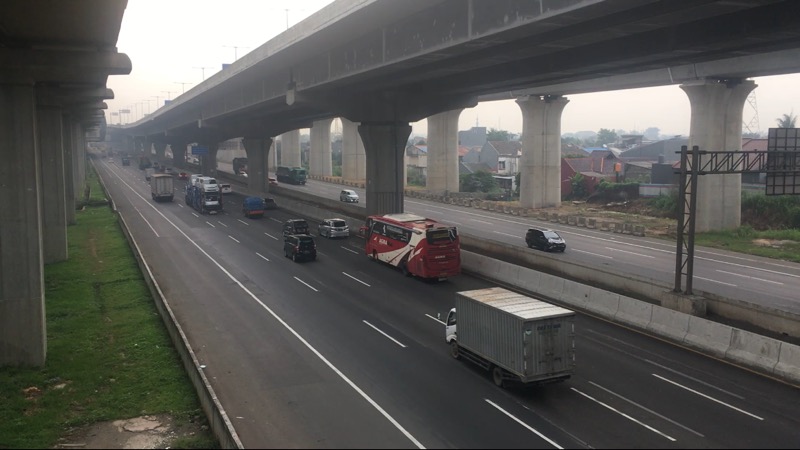 Bus antarkota dan truk logistik berseliweran di Tol Bekasi Timur, Senin (10/1/2022). Foto: BeritaTrans.com.