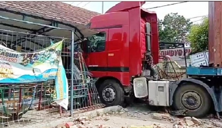 Truk kontainer oleng ke kiri. Mula-mula menjebol pagar besi lalu menghantam Kantor Kepala Desa Sukalila dan Taman Kanak-Kanak. (Foto:iNews.)