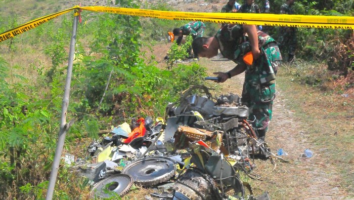  Personel TNI mengecek tumpukan serpihan pesawat tempur latih T-50i Golden Eagle TT-5009 yang jatuh di pegunungan Desa Nginggil, Kradenan, Blora.