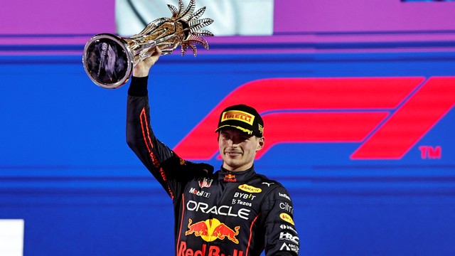 Pembalap Red Bull Max Verstappen merayakan di podium dengan trofi usai balapan F1 Grand Prix Arab Saudi di Sirkuit Corniche Jeddah, Jeddah, Arab Saudi, Minggu (27/3/2022). Foto: Hamad I Mohammed/REUTERS