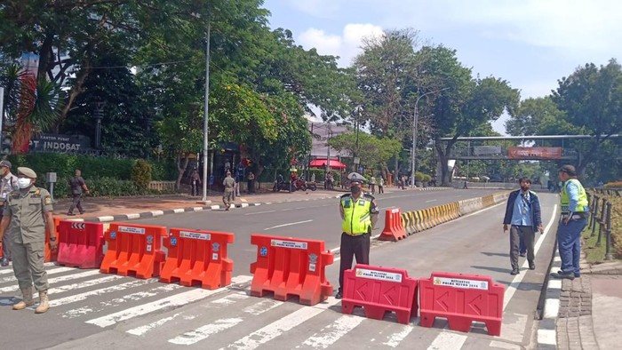 Polisi menutup arus lalu lintas di kawasan Patung Kuda ke istana menjelang demo buruh. 