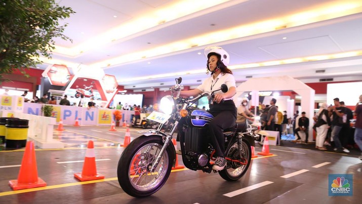 Pengunjung melihat motor lawas yang di konversi menjadi motor listrik pada booth PLN dalam ajang pameran otomotif Indonesia International Motor Show (IIMS) 2023